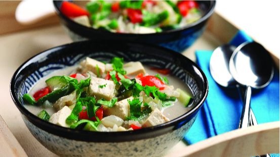 Bowls of tofu cubes, cilantro, red pepper, zucchini and broth 
