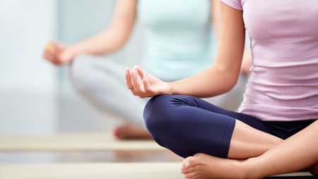 Young people do yoga indoors