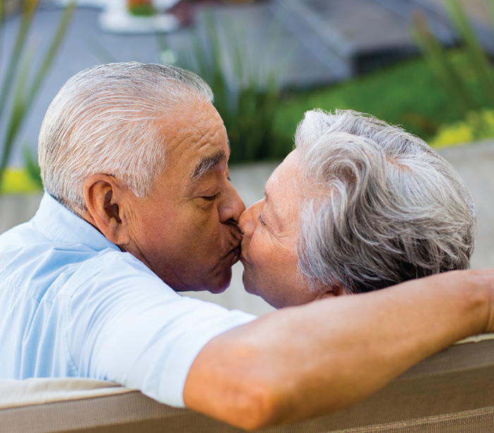 Senior couple, male and female, kissing on the lips 