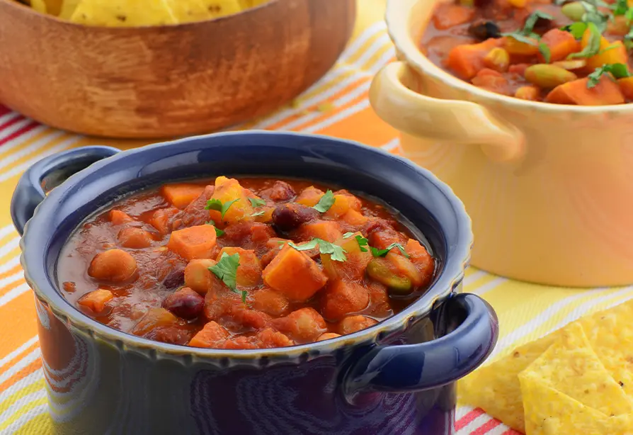 A pot of chili with vegetables.