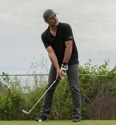 Mark playing golf.